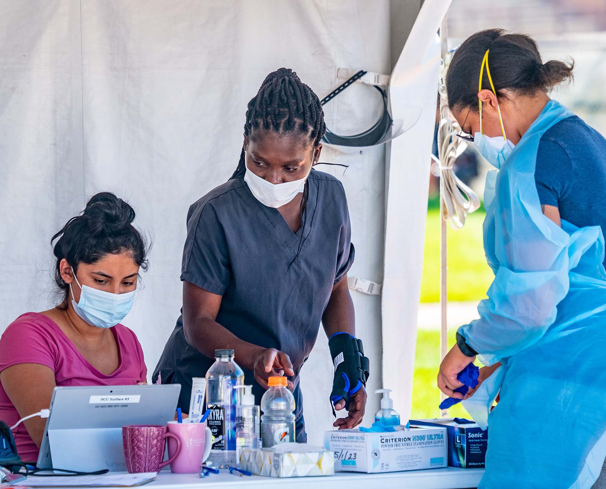 Three people performing COVID testing