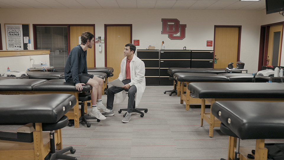 A student conducts physiology research with an athlete