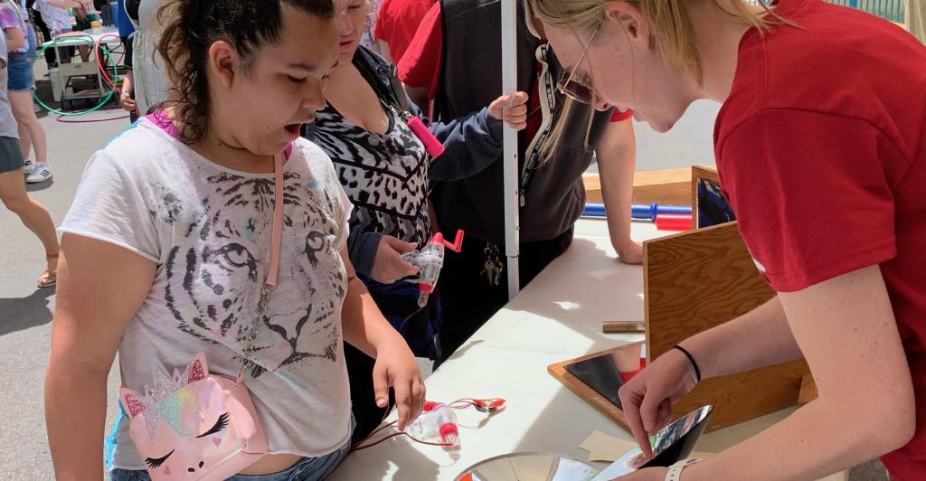 Students demonstrate experiments with kids