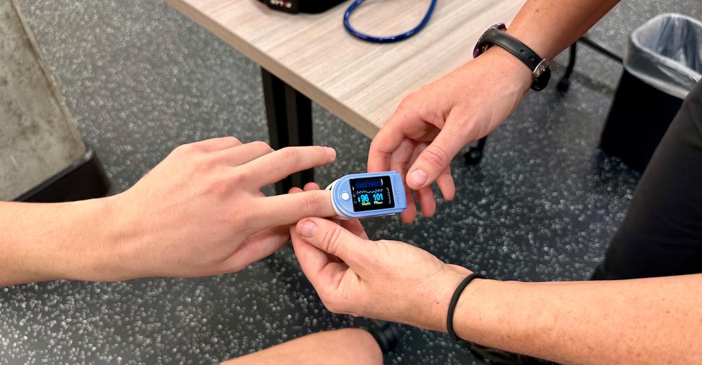 Hands meeting to use fingertip oxygen saturation monitor